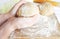 Hands in flour closeup kneading dough