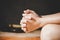 Hands folded in prayer on a Holy Bible in church concept for faith