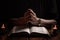 Hands folded in prayer on a Holy Bible in church concept for faith AI generated