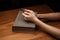 Hands folded in prayer over Holy Bible