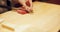 Hands, food and sushi chef cutting fish in restaurant for traditional Japanese cuisine or dish closeup. Kitchen, cooking