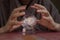 Hands of fortune teller over magical crystal ball with galaxy. Elements of this image are provided by NASA