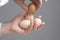 Hands with four hens eggs.