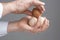 Hands with four hens eggs.