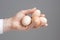 Hands with four hens eggs.