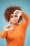 Hands, frame and portrait of black woman on blue background for profile picture. Face, female and finger framing for