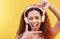 Hands, frame and portrait of woman with headphones on yellow background for profile picture. Face, female and finger