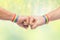 Hands with gay pride wristbands make fist bump