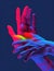 Hands gesture in neon light. Abstarct artistic composition. Bright vivid bold colors. Surrealistic collage artwork. Isolated dark