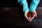 Hands of girl in blue sweater holding coffee beams flat view cop