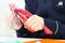 Hands of girl cutting flower from red paper for crafts