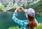 Hands of girl make heart sign on like and mountains background.