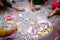 Hands of girls making rangoli - indian mandala. Indian tourism. Indian traditional culture, art and religion. decorative