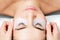 Hands glues ribbon under eyes