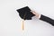 The hands of graduates holding a hat