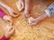 Hands of grandmother and grandchilds at cooking