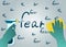 Hands in green gloves with sponge and spray erase the word fear, flat vector with noise and texture.