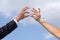 Hands of groom and bride hold wedding rings.