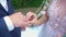 Hands of the groom and bride puts a ring at a wedding ceremony.