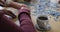 Hands of group of diverse senior friends drinking coffee and doing puzzle at home