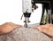 Hands guiding fabric through a vintage sewing machine