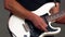 Hands of a guitarist playing an electric guitar