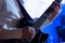 Hands guitarist on the strings. A man in a white shirt plays a black electric guitar. Musical theme. Blue background