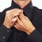 Hands a guy fastened collar of black shirt closeup