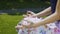 Hands in gyan mudra rack focus, woman sits in park and meditates, proper pose