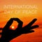 Hands in gyan mudra and text international day of peace