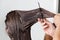 Hands Of Hairdresser Combing Client\'s Hair