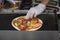 Hands of hands of chef making healthy fresh tortilla, fajitas or fajitos with jamon meat, lettuce and tomatos. National