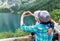 Hands of happy mother make a heart sign for her son near like.