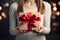 Hands hold a beautiful gift box with a ribbon and white tulips, Gift Giving, Surprise Gift - Ai Generated