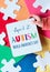 Hands hold board. with text April 2 Autism World Awareness day. Puzzle, layered colorful felt pages