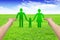 Hands hold paper family on grass, eco concept