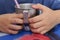 Hands hold stainless cup with straw