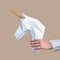 Hands hold a white 3d papercraft model of Unicorn. Minimal Art concept