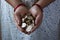 Hands holding 10 rupee coins