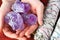 Hands Holding Amethyst Crystals