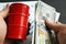 Hands are holding barrel and money. Oil trading