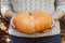 Hands holding beautiful freshly picked organic orange pumpkin.