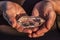 Hands holding a beautiful quartz crystal outdoors in the sun