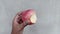 Hands holding a bitten apple