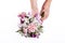 Hands holding a bouquet from pink and purple gillyflowers and al