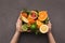 Hands holding box of exotic fruits