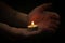 Hands holding candle light