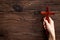 Hands holding christian wooden cross. Faith and prayer concept