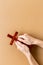 Hands holding christian wooden cross. Faith and prayer concept