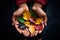 hands holding a collection of colorful autumn leaves,